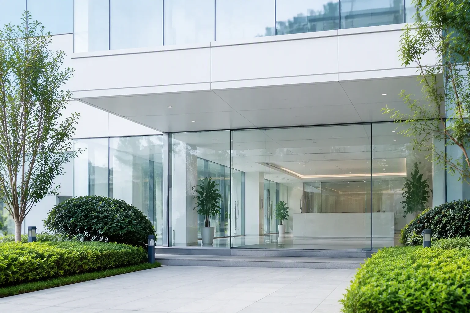 Entrance and reception of an electronics factory building in Shenzhen with a glass facade and greenery